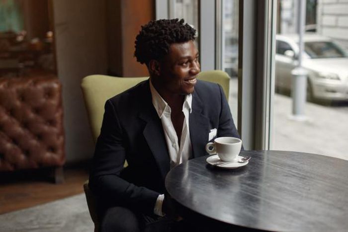 Black man sitting in a cafe [Nohat]
