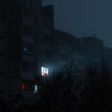 Light on in an apartment buidling [Shutterstock/Dmytro Falkowskyi]