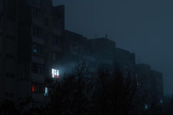 Light on in an apartment buidling [Shutterstock/Dmytro Falkowskyi]