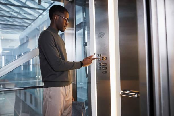Black man inside an elevator [iStock]