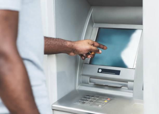 Black man at an ATM [iStock]