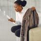Black woman with suitcase at the airport [Freepik]