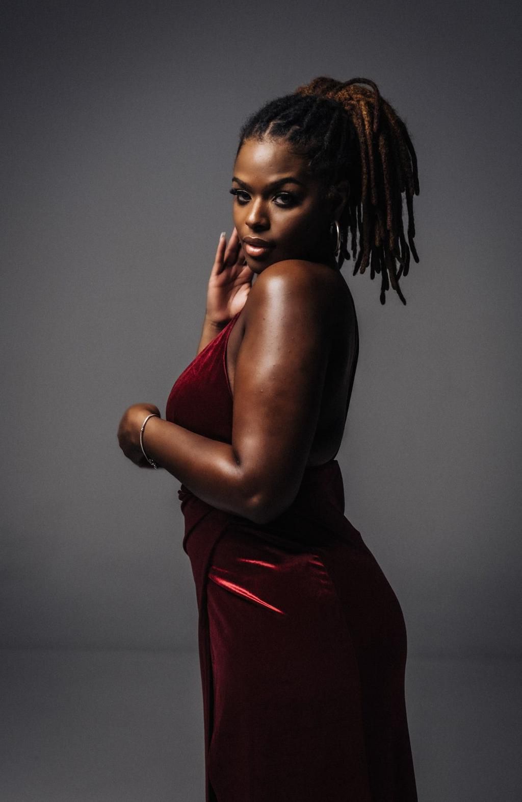 Woman with braided hair wearing an elegant dress [Image Credit: Jaycees]
