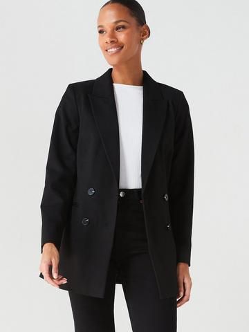 A woman wearing a structured jacket