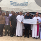 The LP Presidential Candidate in the 2023 General Elections, Mr Peter Obi, sandwiched by two priests, while presenting a cheque for N10 million donation to the Holy Rosary College of Nursing, Emekuku, Owerri, on Saturday [NAN]
