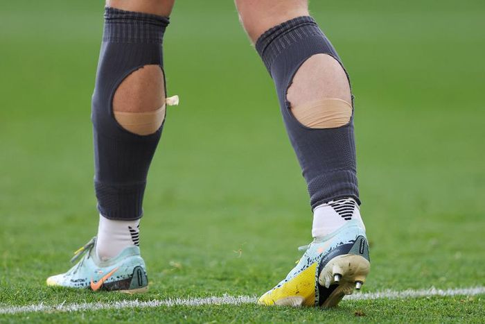 Why do so many footballers cut holes in their socks? [huffpost]