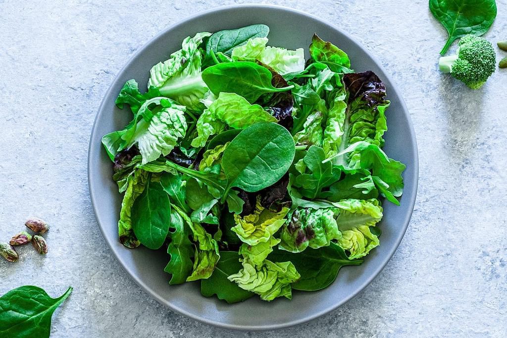 Adding dark leafy greens to your salad can help diversify your diet.fcafotodigital/Getty Images