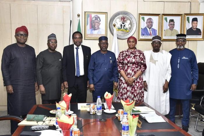 Minister of State Petroleum Resources (Gas) and Chairman, Governing Council of the Midstream Downstream Gas Infrastructure Fund (MDGIF), Mr Ekperikpe Ekpo (middle) with members during the inauguration meeting of the Council in Abuja [NAN[