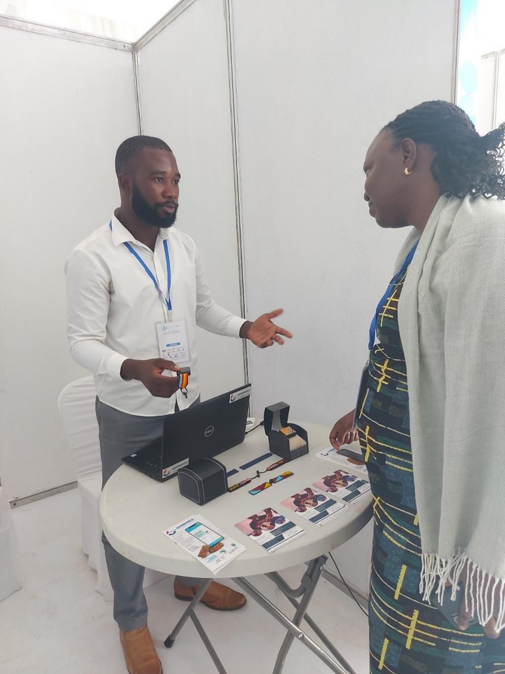 Saul Kabali, Executive Director and Chief Operations Lead at SafeBangle Technologies explaining how the bracelet works at 2023 Imara Girls Festival exhibition