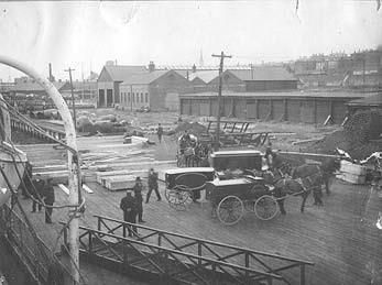 Bodies of Titanic victims being unloaded from the Minia in Halifax Harbor [Nova Scotia Museum]
