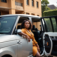 An AI-generated image of a very beautiful African lady coming out of a Range Rover