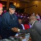 L-R: Enugu State Governor, Peter Mbah; Ogun State Governor Dapo Abiodun in handshake with Mr. Gbenga Komolafe winner of The Sun Public Service Award in Lagos. [TheSun]