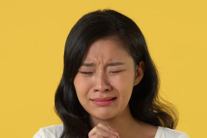 A Chinese woman crying [Shutterstock]