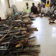 Members of the Yansakai vigilante group sit inside an auditorium at the Zamfara State Government house as their members surrendered more than 500 guns. [Getty Images]