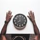 Round black and white analog wall clock in front of a man [Usplash]