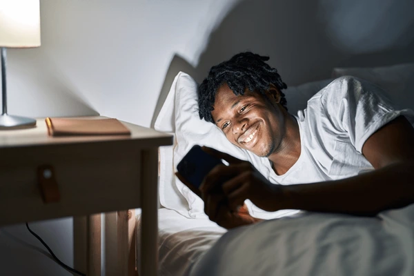 Black man in bed [Shutterstock]