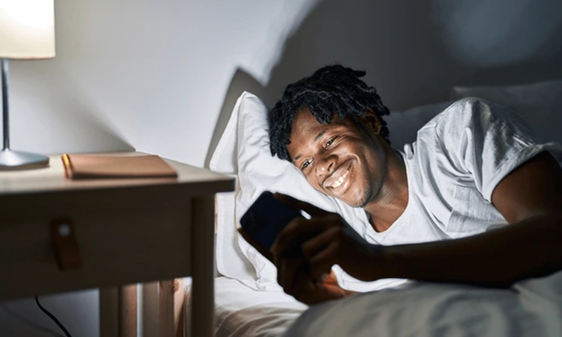 Black man in bed [Shutterstock]