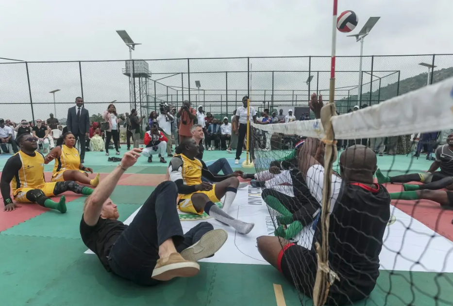 Prince Harry takes part in an exhibition sitting volleyball match [Kola SULAIMON / AFP]