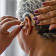 An elderly woman wearing hearing aid