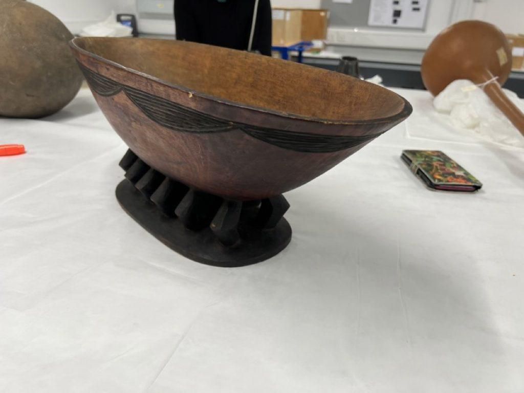 The return includes a collection of "balongo," sacred figures with ritual significance in Buganda culture