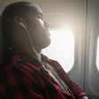 Black man sleeping on a plane [Getty/Jose Luis Pelaez]
