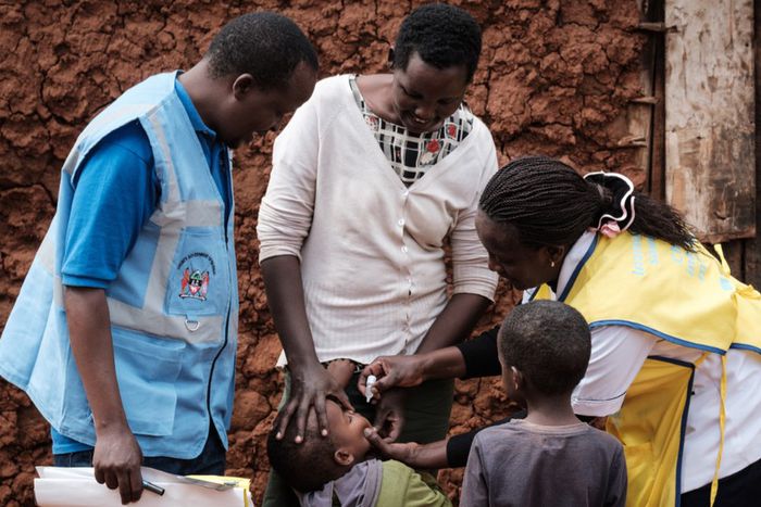A boy receives drops of polio vaccine by a home-visited nurse after the launching ceremony of the five-day polio vaccination campaign in high risk counties. [Getty Images]