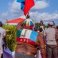 An APC party supporter waves the party's flag at an election campaign rally in Edo State [Twitter/@PastorIzeIyamu]