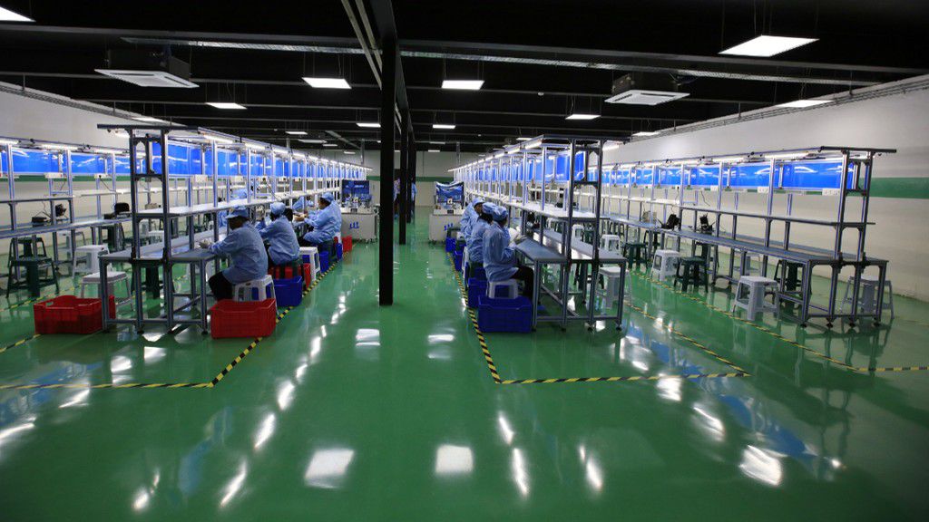 Workers sort packs of AfriOne Gravity Z1 smartphones during a launch event at the new AfriOne Ltd. manufacturing plant in Lagos, Nigeria. [Getty Images]
