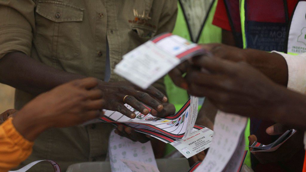 Independent National Electoral Commission (INEC) officials sort and count ballots during the vote counting process at a polling station in Kano on February 25, 2023, during Nigeria's presidential and general election. [Getty Images]