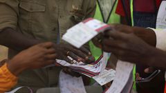Independent National Electoral Commission (INEC) officials sort and count ballots during the vote counting process at a polling station in Kano on February 25, 2023, during Nigeria's presidential and general election. [Getty Images]