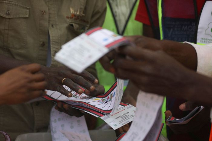 Independent National Electoral Commission (INEC) officials sort and count ballots during the vote counting process at a polling station in Kano on February 25, 2023, during Nigeria's presidential and general election. [Getty Images]