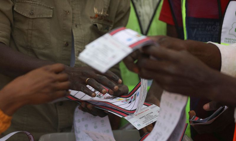 Independent National Electoral Commission (INEC) officials sort and count ballots during the vote counting process at a polling station in Kano on February 25, 2023, during Nigeria's presidential and general election. [Getty Images]