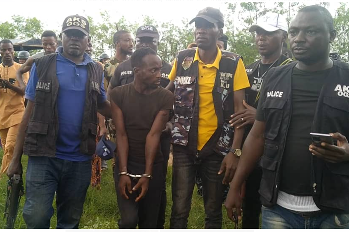Ogunnaike Philip leading security operatives to one of the grave sides [Punch]