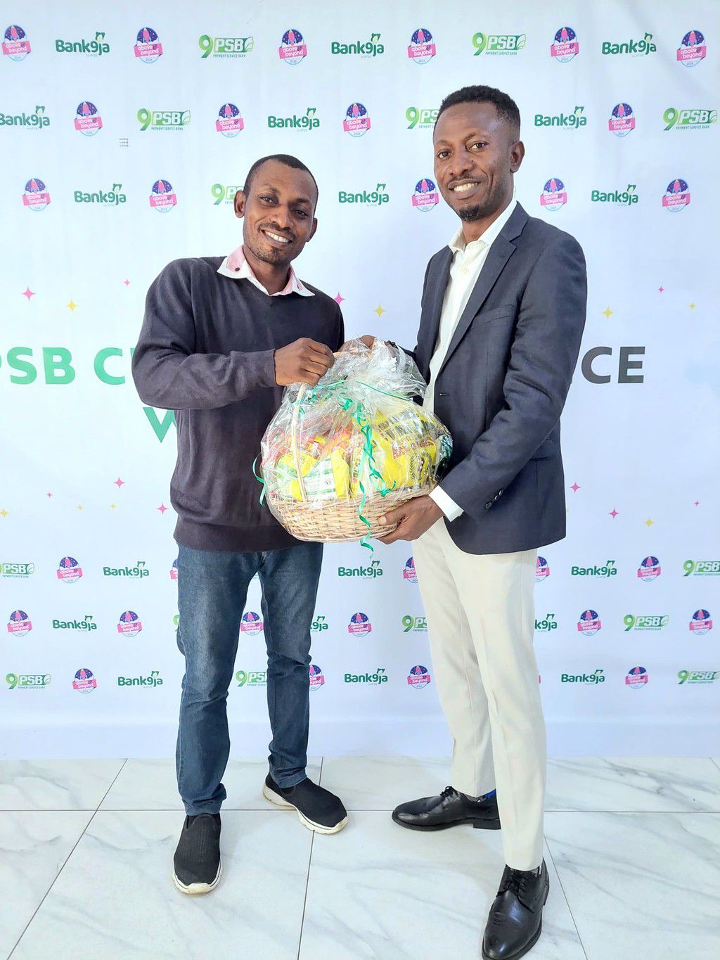 Lead, Agency and Merchant Acquisition, 9 Payment Service Bank, Jephthah Onyema Mark (right) presenting a gift of recognition to Anthony Afolayan a 9PSB Agent during the 2024 Customer Service Week held at the bank’s head of in Victoria Island, Lagos