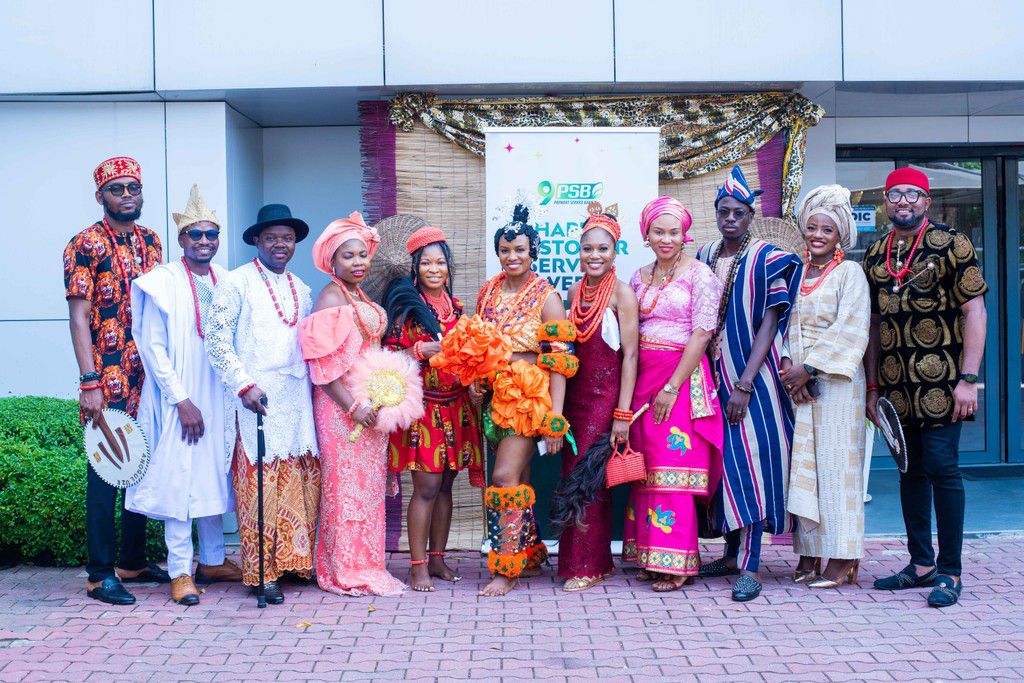 A cross section of 9 Payment Service Bank Staff posed in their traditional attire during the 2024 Customer Service Week activity held at the bank’s head of in Victoria Island, Lagos