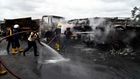 Fire fighters extinguish a fire from a tanker laden with gas and trucks that burst into flames following an accident at Ogere on Lagos - Ibadan expressway.  [Getty Images]