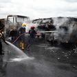 Fire fighters extinguish a fire from a tanker laden with gas and trucks that burst into flames following an accident at Ogere on Lagos - Ibadan expressway.  [Getty Images]