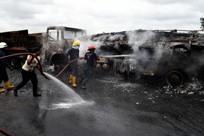 Fire fighters extinguish a fire from a tanker laden with gas and trucks that burst into flames following an accident at Ogere on Lagos - Ibadan expressway.  [Getty Images]