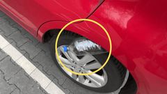 Car thieves wedge a plastic bottle against the front tyre