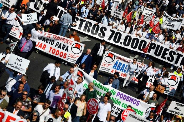 Demonstrators in Madrid chanted "Let us work!" as they made their way along the city's Paseo de la Castellana, accompanied by about 40 cars with tinted windows to the public works ministry