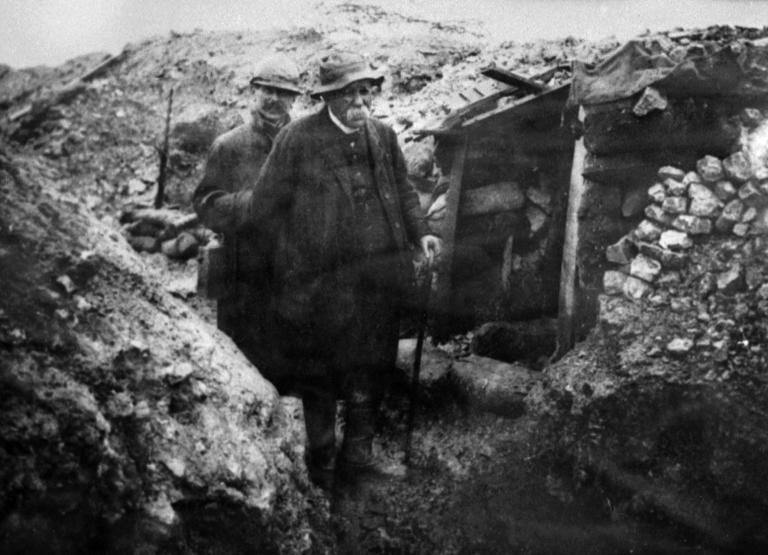 French prime minister Georges Clemenceau walks along a trench during World War I