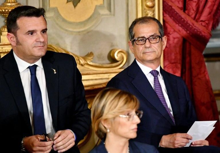 Economy Minister Giovanni Tria (R) is under pressure to produce what Italy's anti-establishment leaders say would be a "courageous" budget
