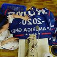 A worker at a factory in China sews a banner for US President Donald Trump's re-election campaign that reads "Trump 2020: Keep America Great"