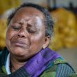 Askale Adacha, 63, weeps as she speaks about fleeing the violence on the outskirts of the Ethiopian capital