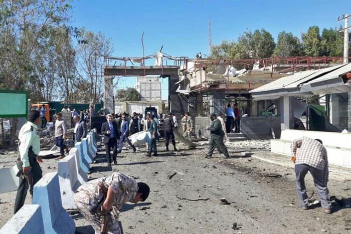 Iranian police survey the aftermath of a suicide car bombing which killed at least two people and wounded many more outside police headquarters in the southeastern port city of Chabahar