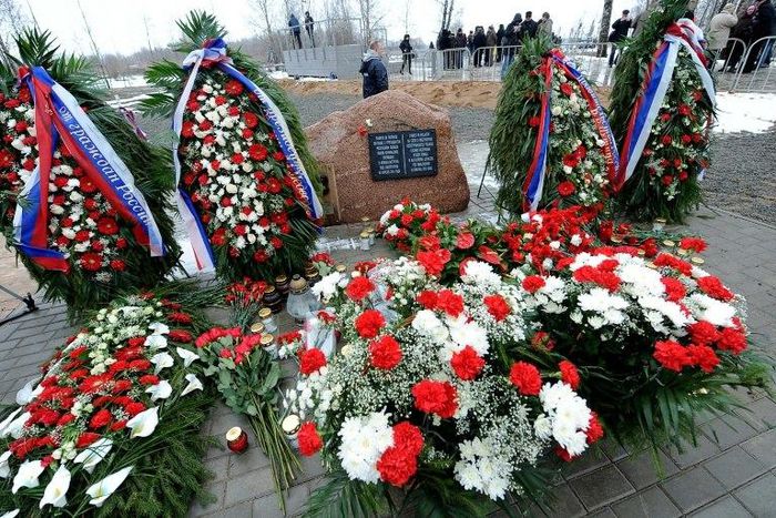 A memorial stone with a plaque which reads in Russian and Polish "To the memory of 96 Poles headed by Polish Republic President Lech Kaczynski, who died in the air disaster near Smolensk on April 10, 2010" at the site of the crash is seen April 2011