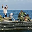 A fisherman from the Democratic Republic of Congo raises his hands to surrender to Uganda forces patrolling Lake Edward, which is shared by the two countries