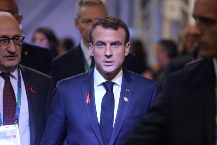 The violent street protests in Paris have raised questions abroad if President Emmanuel Macron (C) is still able to reform France - let alone the European Union