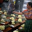 Indigenous women burn incense over urns with the remains of victims from Guatemala's 1960-1996 civil war after they arrived in San Juan Comalapa, Chimaltenango department, west of Guatemala City