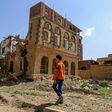 A Yemeni child walks towards a building that was reportedly destroyed in a previous Saudi-led coalition air strike in Sanaa, on September 5, 2018